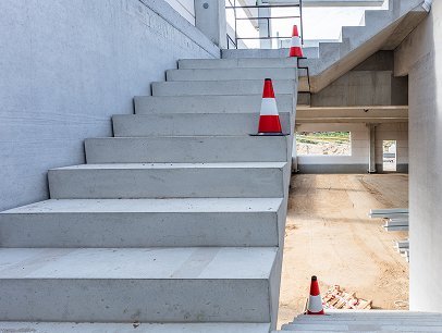 Concrete staircase with safety cones at G&G Concrete Inc. construction project.