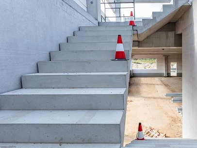 Concrete staircase with safety cones at G&G Concrete Inc. construction project.